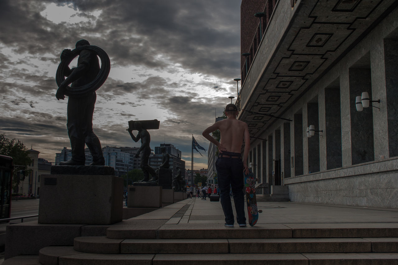 PEOPLE STANDING BY BUILDING IN CITY