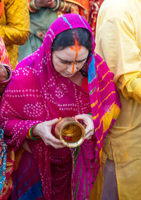 Indian women praying to hindu almighty sun god at chhath festival