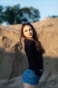 Portrait of young woman standing outdoors
