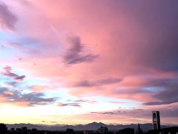 Low angle view of silhouette buildings against sky during sunset