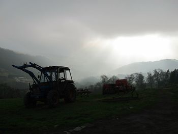 Tractor on farm against sky