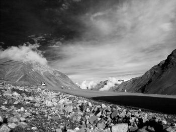 View of rocky landscape against mountain range