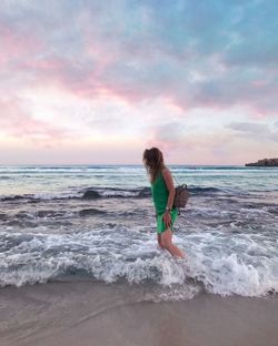 Full length of woman on beach against sky