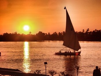 Sailboat on nile river against sky during sunset