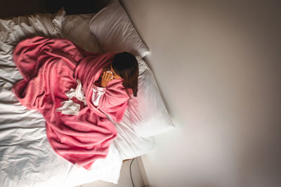 High angle view of woman on bed at home