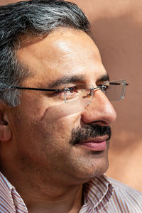 Close-up portrait of man wearing eyeglasses