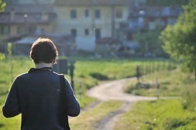 Rear view of woman standing on field