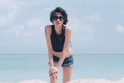 Young woman standing at beach