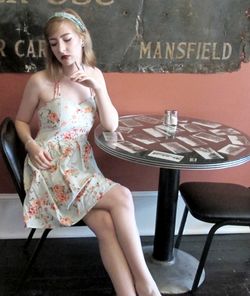 Young woman sitting on table