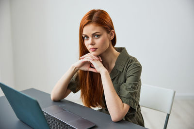 Young woman using laptop at home