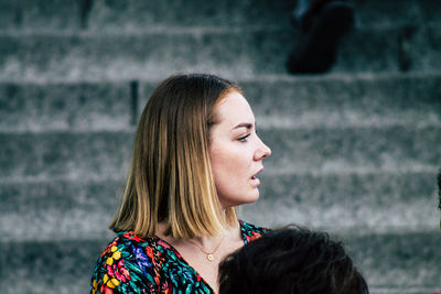 Portrait of young woman looking away outdoors