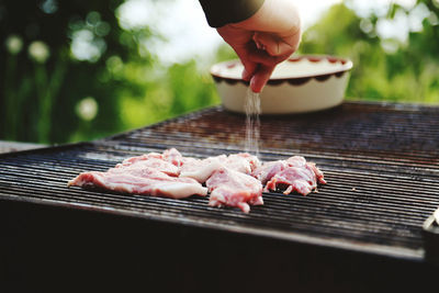 Cropped hand of person preparing food