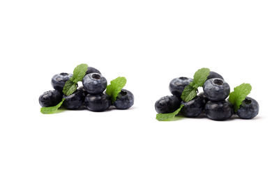 Close-up of blueberries against white background