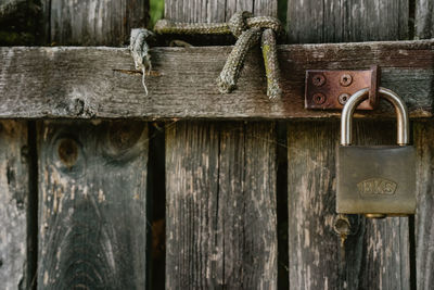 Close-up of padlock on wooden door