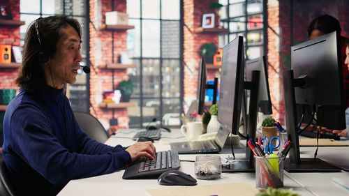 Young woman using mobile phone in office