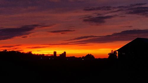 Silhouette of building against dramatic sky