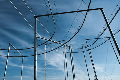 Low angle view of electricity pylon against sky