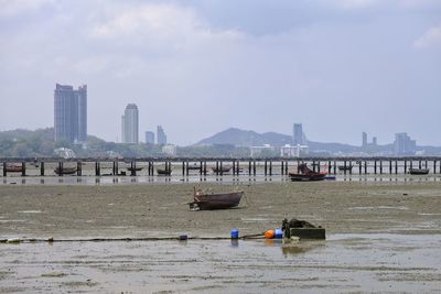 Scenic view of sea by buildings against sky