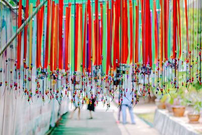 Multi colored umbrellas hanging in row