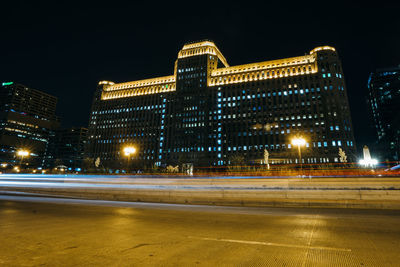 Illuminated buildings against sky at night