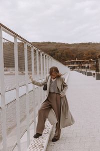 Rear view of woman standing at beach