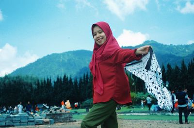 Full length of woman standing against sky