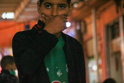 Portrait of young man standing outdoors