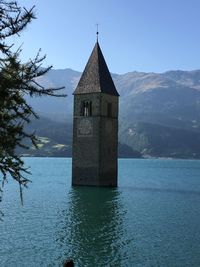 Building by mountain against sky