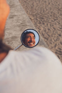 Happy man riding bike on beach