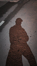 High angle view of shadow of person on road