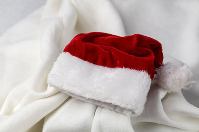 High angle view of santa hat on white textile