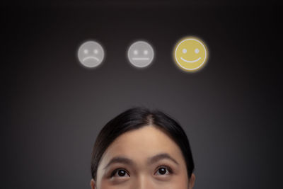 Portrait of woman against black background