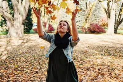 Portrait of young woman standing in autumn