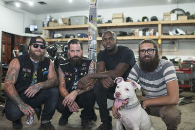 A group of young men with a dog.