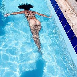 High angle view of woman swimming in pool