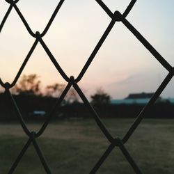 Close-up of chainlink fence against sky