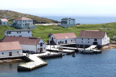 High angle view of townscape by sea against sky