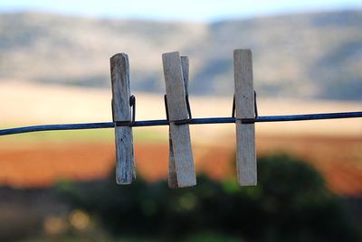 Close-up of clothespins hanging on string