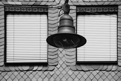 Low angle view of electric lamp on building