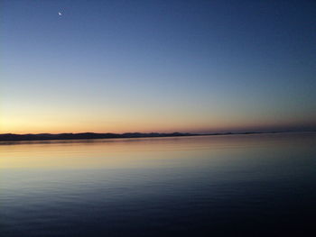 Scenic view of sea against clear sky during sunset