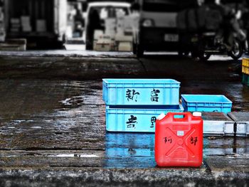 Crates on wet footpath