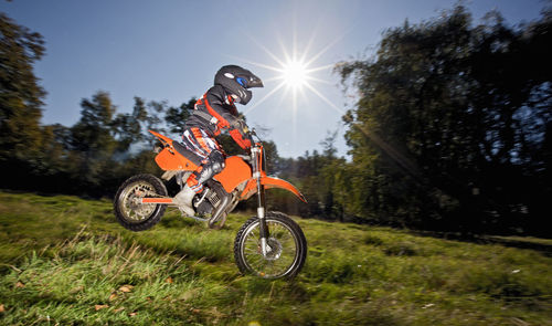 12 year old boy jumping with his off road motorbike