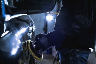 Midsection of man cleaning car