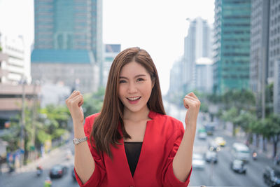 Portrait of a smiling young woman in city