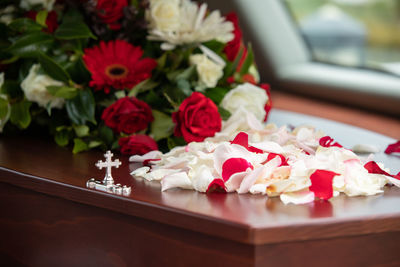 Closeup shot of a funeral casket or coffin in a hearse or chapel or burial at cemetery
