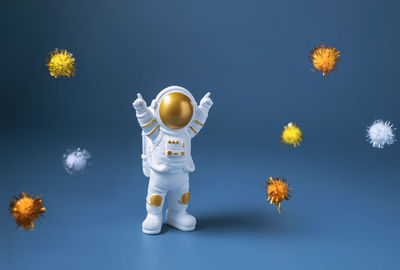 Happy astronaut standing with raised hands