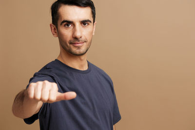 Portrait of young man against red background