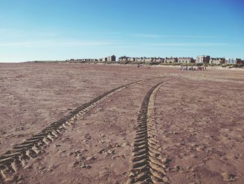 High angle view of tire tracks at beach