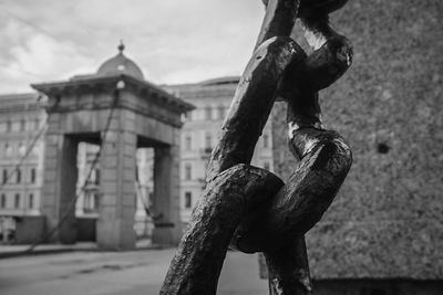 Close-up of statue against built structure