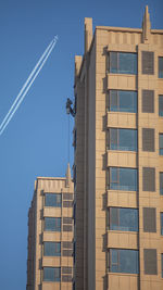 Low angle view of modern building against clear blue sky
